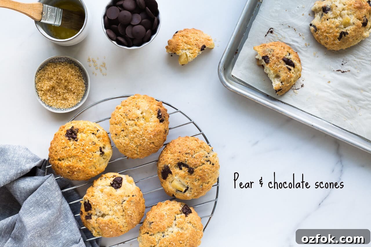 Chocolate Pear Scones: Flaky Scones with Poached Pear Pieces 2 Transferring freshly baked pear chocolate scones sprinkled with melted butter and turbinado sugar from a sheet pan to a cooling rack