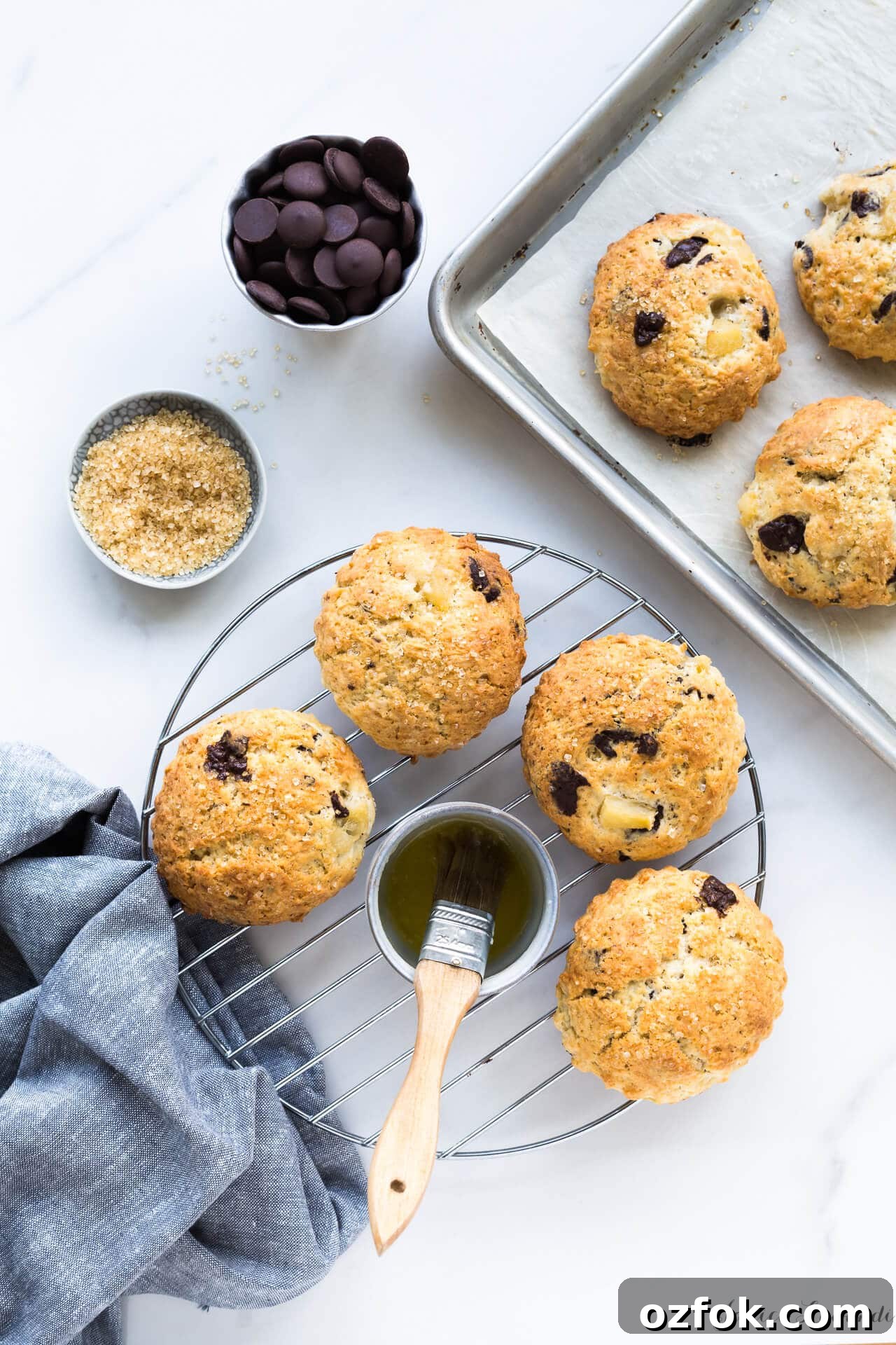 Chocolate Pear Scones: Flaky Scones with Poached Pear Pieces 4 Transferring pear chocolate scones brushed with butter and sprinkled with turbinado from sheet pan to cooling rack