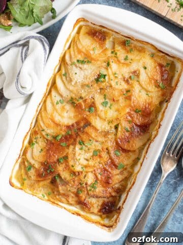 Boulangere potatoes in a white ovenproof dish.