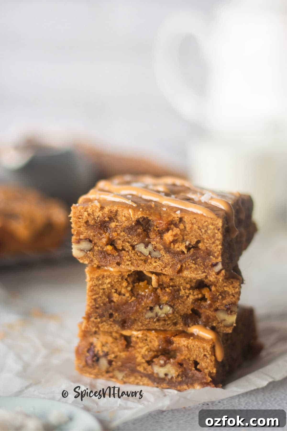 Eggless Butterscotch Blondie Recipe — Moist, Chewy Bars 2 stacked eggless butterscotch blondies placed on a parchment paper