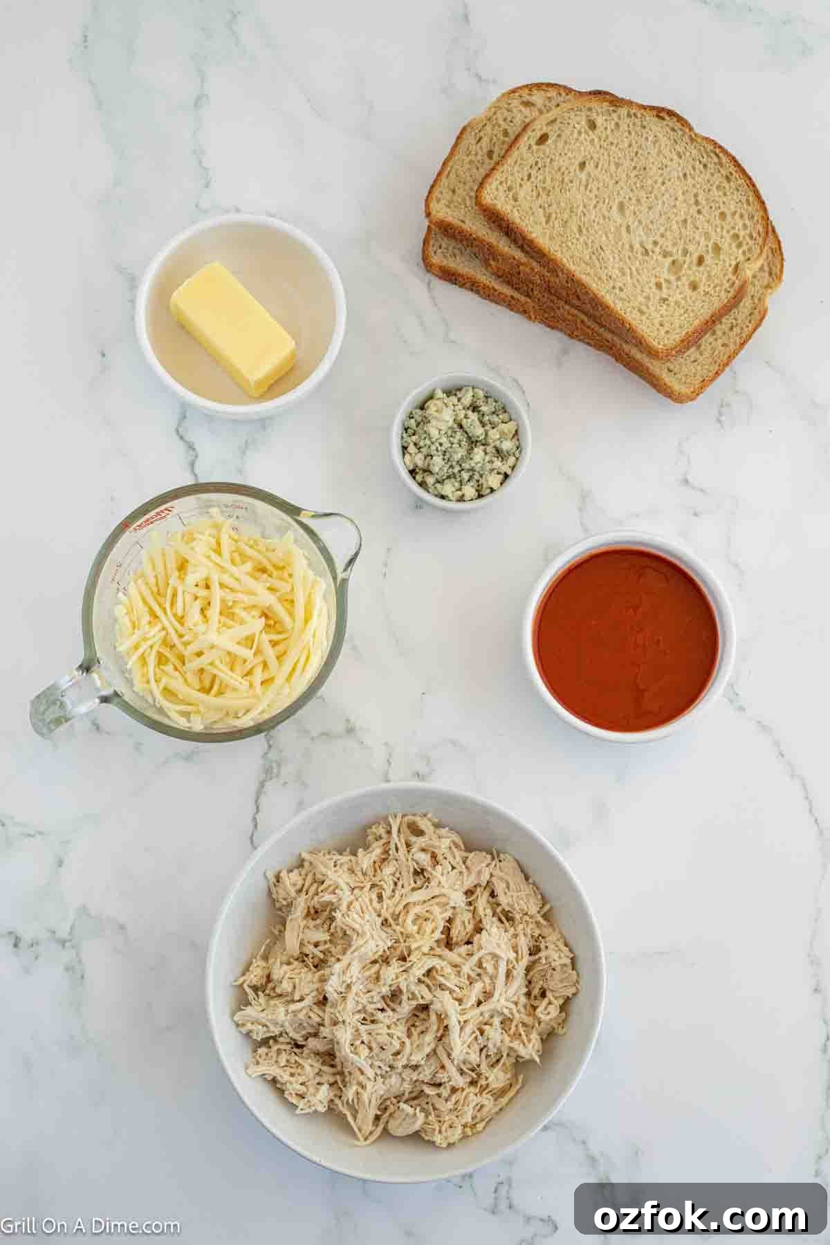 Ingredients needed - bread, cooked chicken, buffalo sauce, butter, blue cheese crumbles, monterey jack cheese