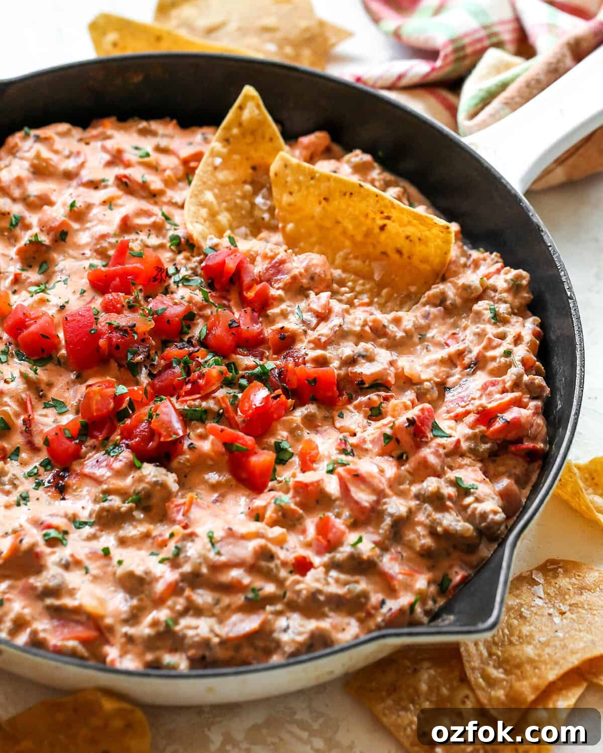 Cream Cheese Sausage Dip in a skillet with chips 