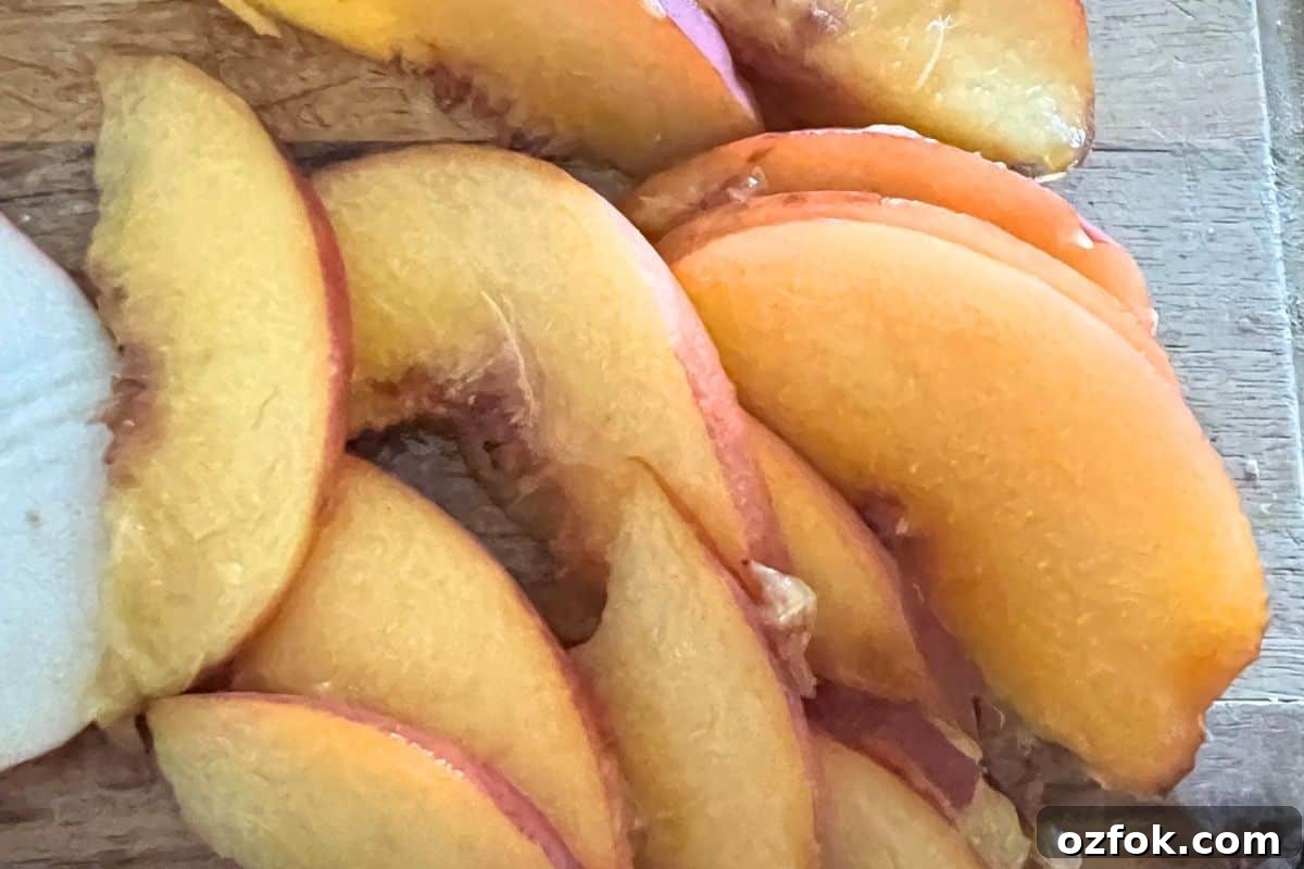 Sliced peaches on a cutting board.