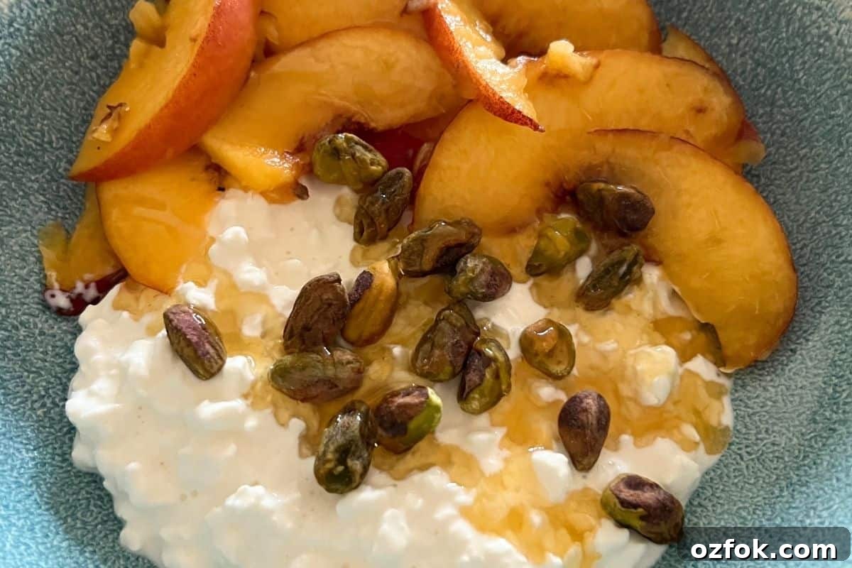 Finished peaches and cottage cheese served in a bowl.