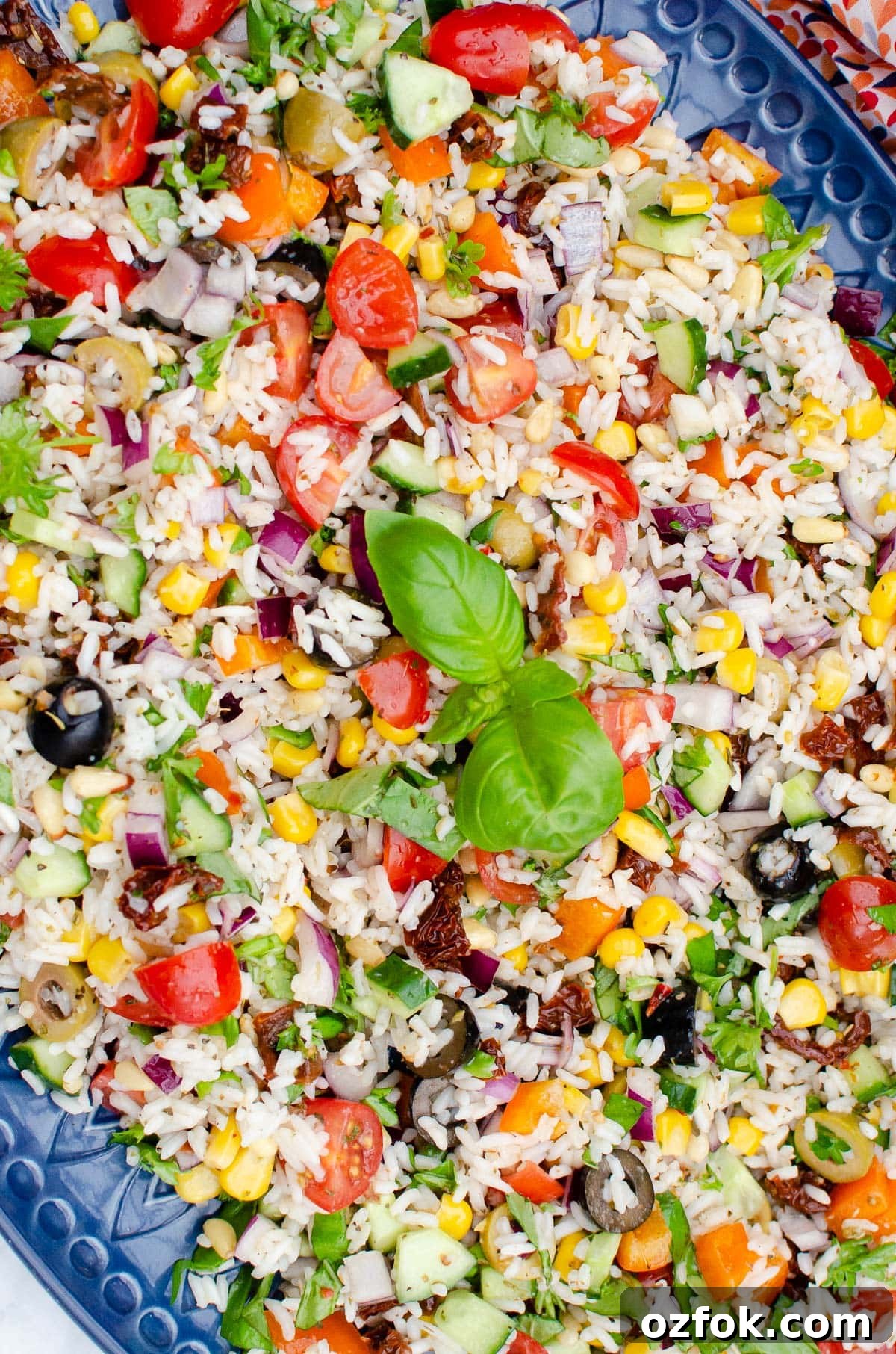 Italian Style Rice Salad on a large blue platter plate