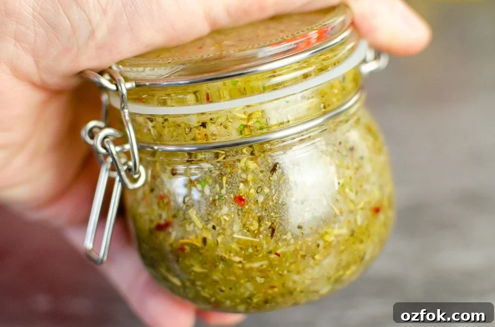 Shaking the Italian salad dressing together in a glass pot