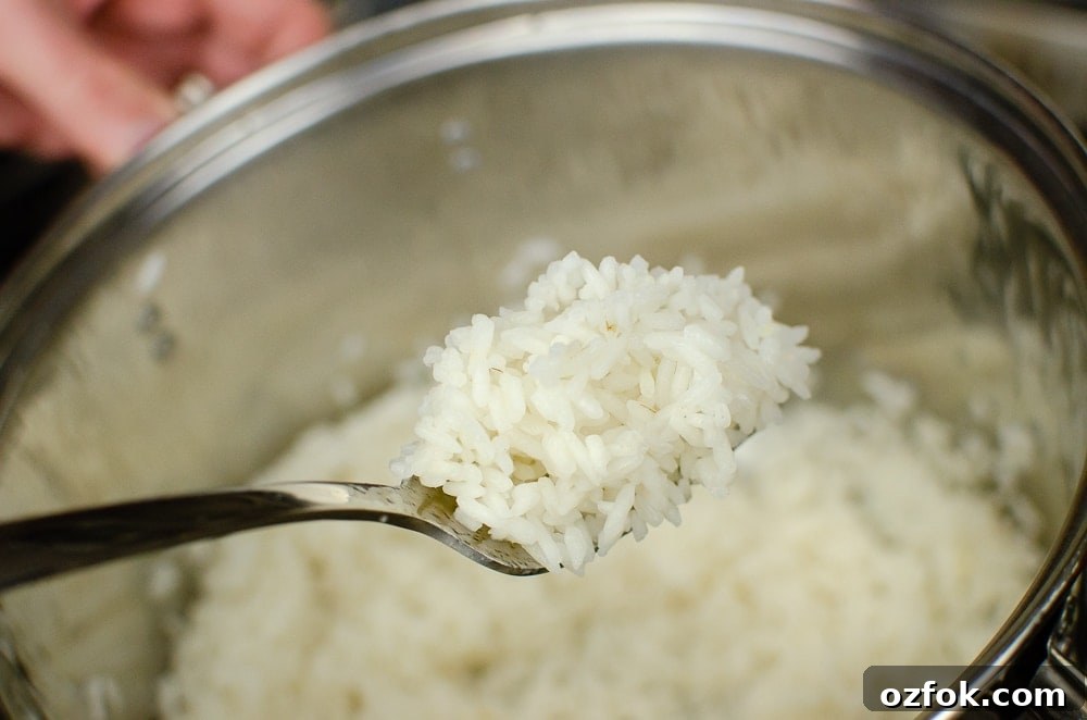 Cooked long grain rice on a fork ready to serve with our Italian style rice salad