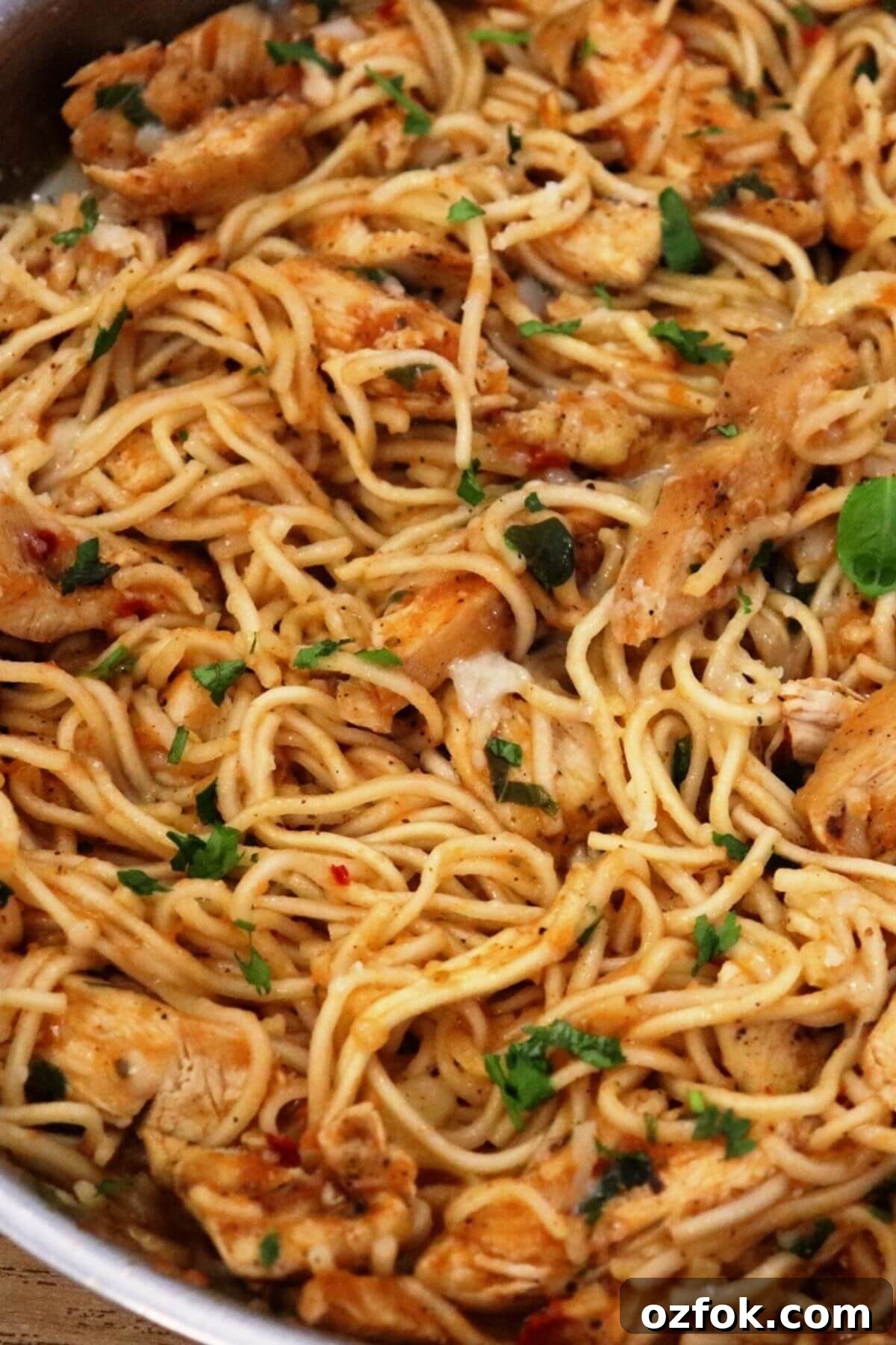 spicy chicken spaghetti in a pan.