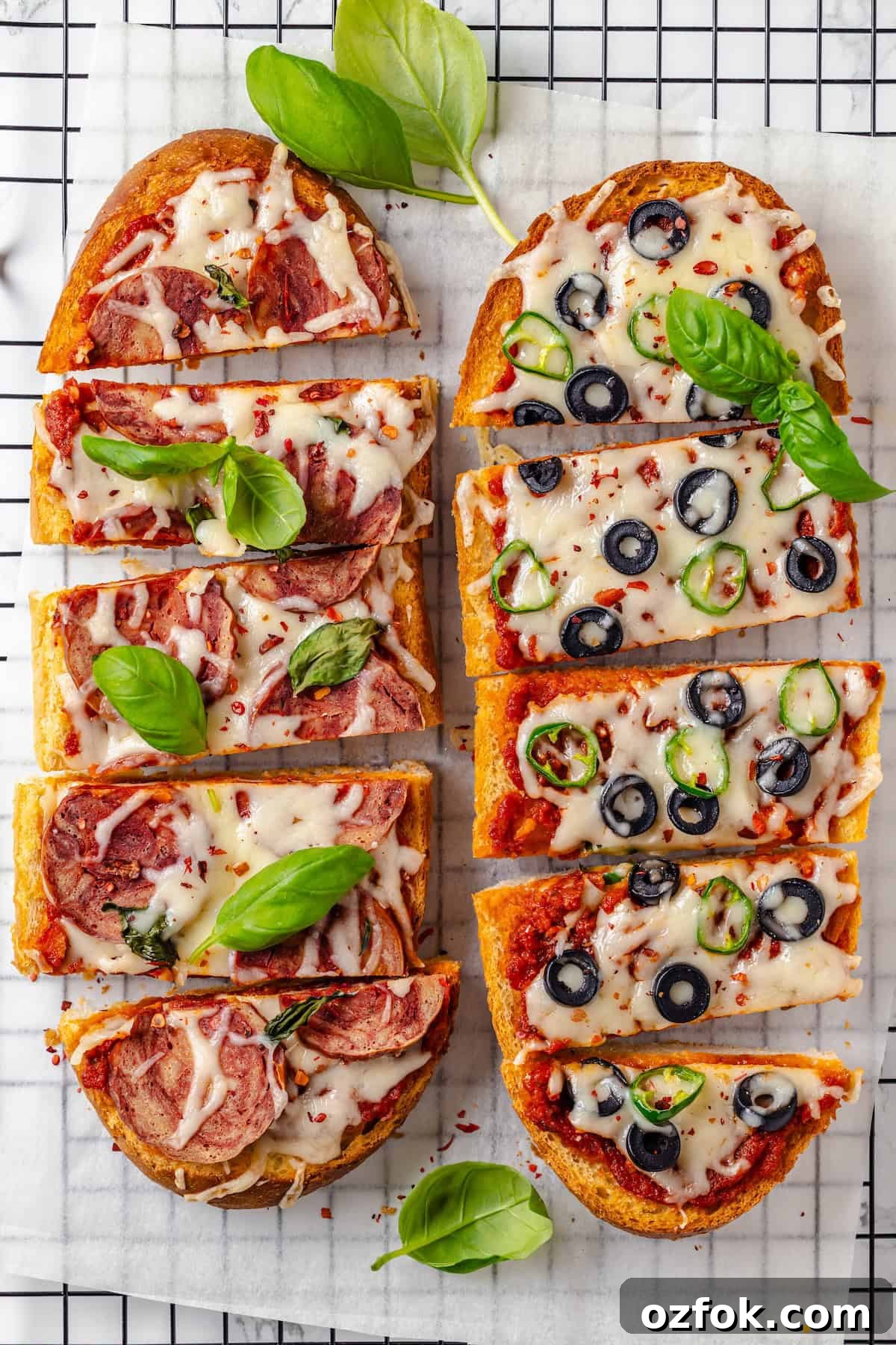 Overhead view of 2 vegan French bread pizzas on wire rack
