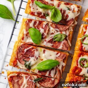 Overhead view of sliced vegan French bread pizza on wire rack
