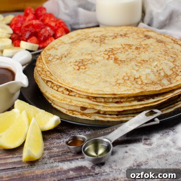 A stack of Easy English Pancakes on a black plate