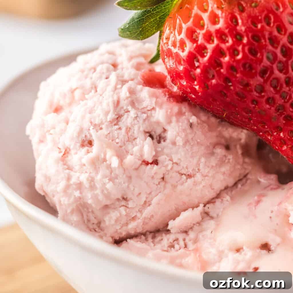 A close up of a scoop of strawberry ice cream.