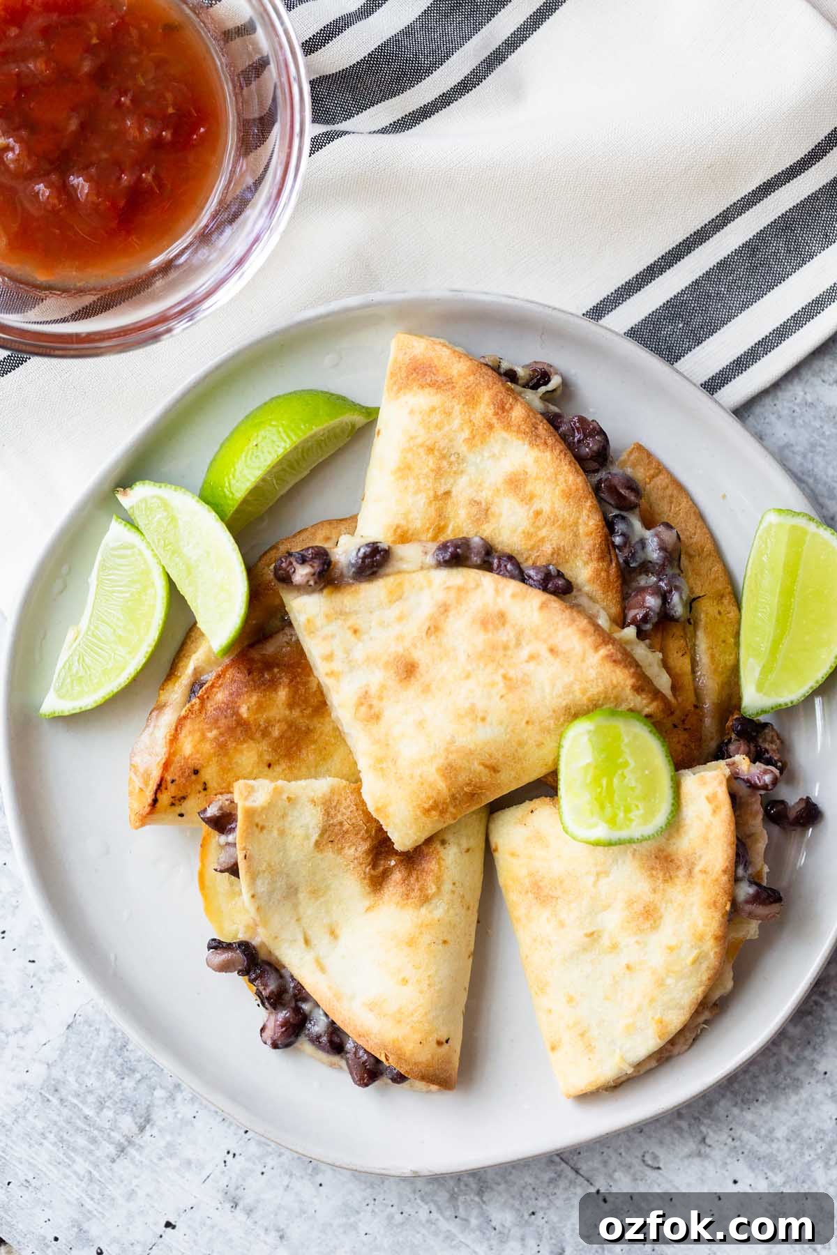 quesadillas on a plate with lime wedges