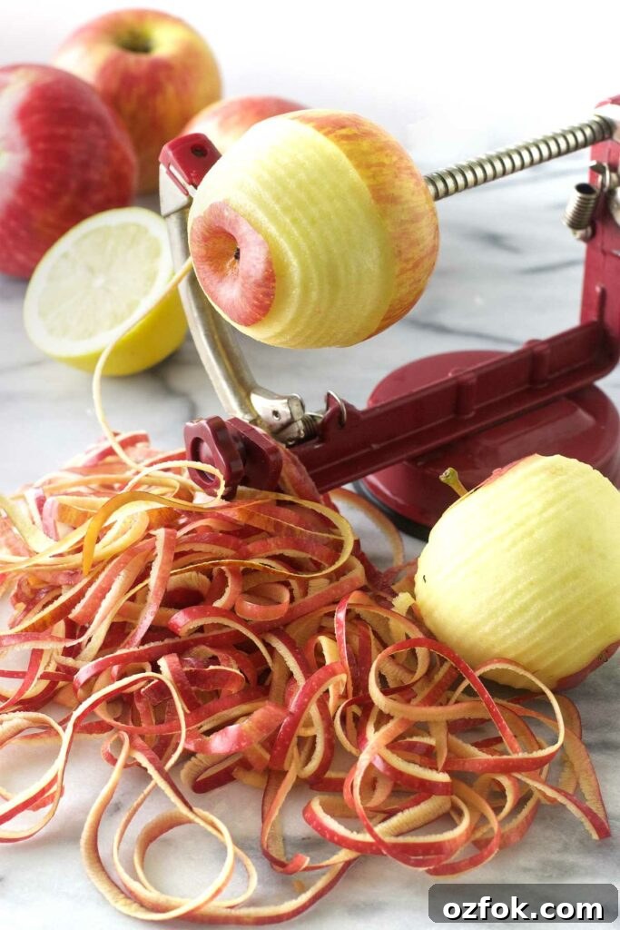 Using an apple peeler-corer-slicer to peel apples.